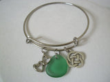 Stainless steel adjustable bracelet with sea glass and charms